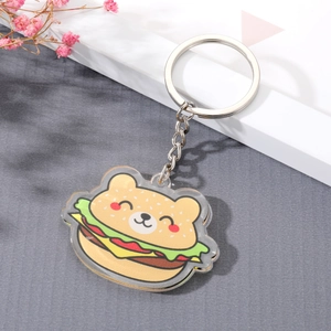 Detailed close-up of a cute burger bear acrylic keychain on a decorative background