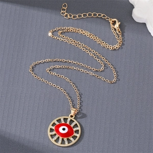 Detailed close-up of gold Evil Eye necklace with red enamel and sparkling crystal pavé