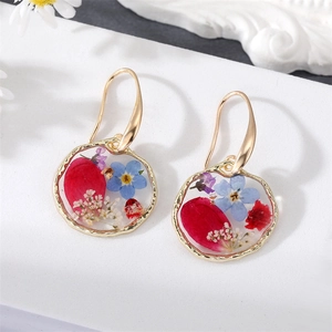 Floral resin hoop earrings with red and blue dried flowers and gold foil accents