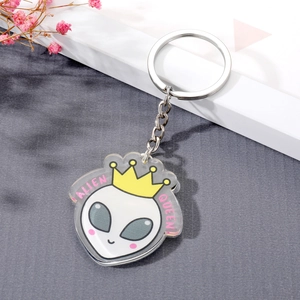 Creative acrylic alien queen keychain with yellow crown and cute cartoon design on grey background