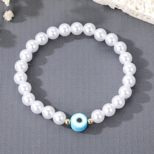 Fashionable freshwater pearl bracelet with blue Evil Eye charm and golden beads