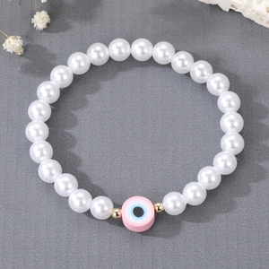 Fashionable freshwater pearl bracelet with pink evil eye pendant and gold accents