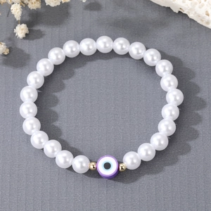 Elegant freshwater pearl bracelet with purple evil eye pendant and gold spacer beads