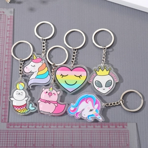 Set of six colorful acrylic unicorn keychains featuring cartoon designs and metallic rings