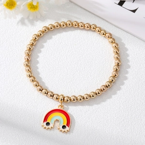 Detail of gold beaded bracelet featuring a colorful rainbow charm with cute eye details
