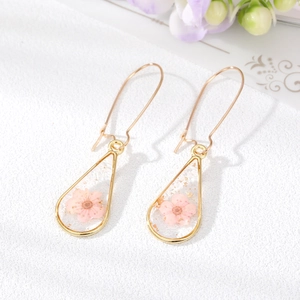 Handmade teardrop resin earrings with pink dried flowers and gold leaf foil accents
