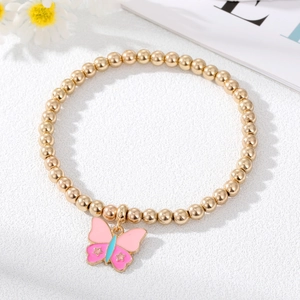 Detail of golden beaded elastic bracelet featuring a colorful enamel butterfly pendant
