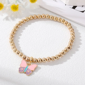 Detailed close-up of a golden beaded bracelet with a pink and purple butterfly charm