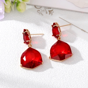 Elegant gold earrings with fan-shaped red crystal drops in a 45-degree angle view
