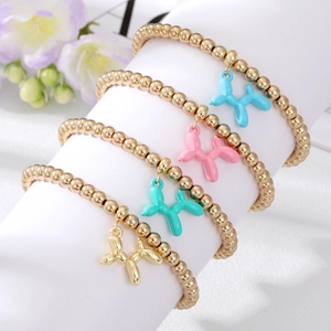 Set of four gold bead bracelets with colorful balloon dog charms on a white display