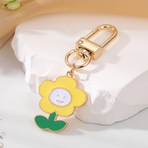 Cute cartoon yellow smiley flower keychain with golden lobster clasp and petal design