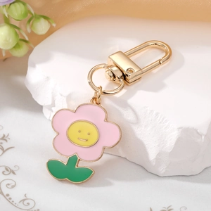 Detailed view of a cute colorful flower keychain on a decorative white stone background