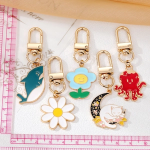 Detail view of colorful cartoon alloy keychains with whale and flower charms for bags