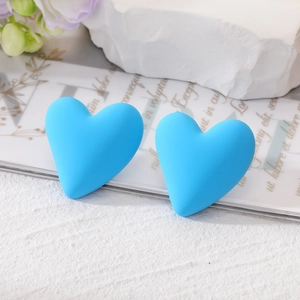 Chic royal blue heart stud earrings with matte finish on elegant decorative background