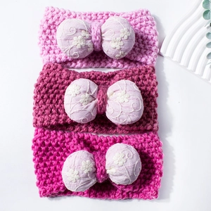 Three-piece set of knitted baby headbands with embroidered bows in pink and purple shades