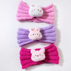 Three knitted baby headbands in pink, purple, and magenta with cute plush animal bunnies