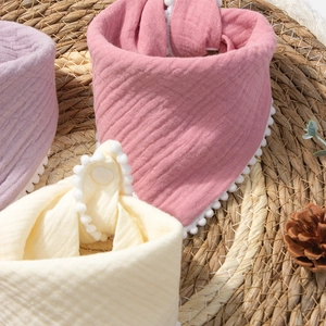 Thick cotton gauze baby bibs with decorative pom pom fringe and adjustable snap buttons