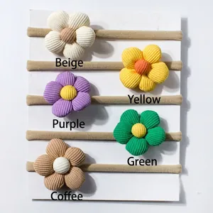 Cinque fasce elastiche a fiori in velluto a coste nei colori beige, giallo, viola, verde e marrone