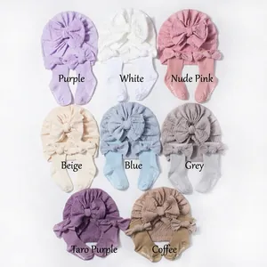 Detailed flat lay of baby jacquard bow hat and socks set in eight different colors