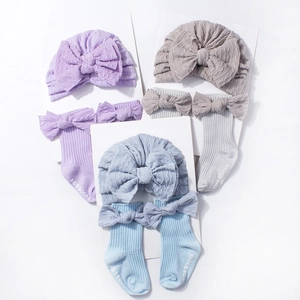 Infant jacquard knit hat and socks set with large bow detail in multiple colors