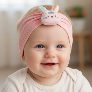 Detailed view of soft pink knitted baby headband featuring a 3D rabbit applique ornament