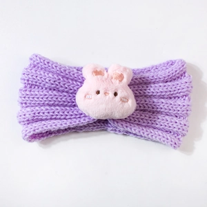 Detailed knit texture of purple baby headband with a cute pink plush bunny decoration