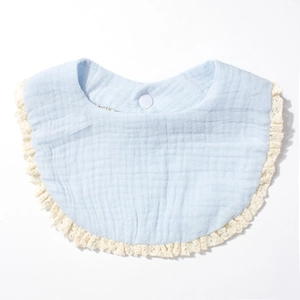 Close-up of baby bib featuring soft blue cotton gauze fabric and white lace trim detail