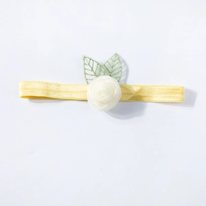 Elastic baby headband with a white mesh rose and green leaves on a yellow band