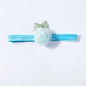 Detailed top view of a sky blue elastic baby headband with a soft mesh rose and green leaves
