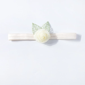 Detailed close-up of ivory rose headband with delicate green embroidered leaves for babies