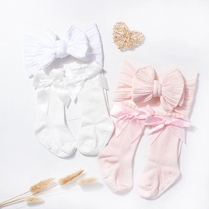 Detail of baby bow headband and ribbed cotton socks with anti-slip soles in gift set