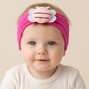 Close-up of hot pink knitted baby headband with cute plush bee decoration on infant