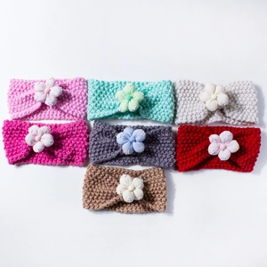 Set of seven colorful knitted baby headbands with delicate handmade flowers and pearls