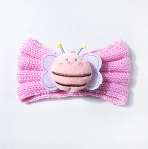 Detail of baby pink knitted headband with a soft plush honeybee character on center