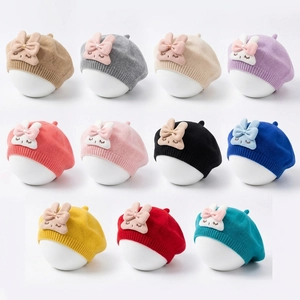 Detailed display of 11 colors of baby bunny ear berets in a soft knitted fabric