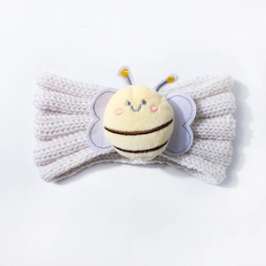 Close-up of soft knitted baby headband with cute 3D bee decoration and detailed knit texture
