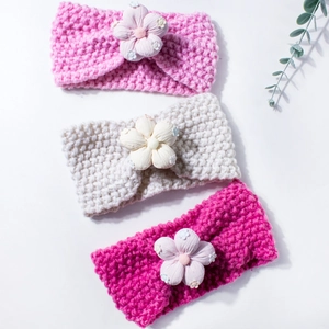 Three-piece set of knitted baby headbands with 3D flowers in pink, beige, and rose red