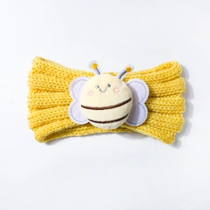 Detailed view of the yellow knitted baby headband featuring a plush 3D cartoon bee motif