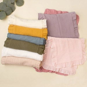 Muslin cotton baby burp cloths with ruffle edges in various Morandi colors shown in flat lay