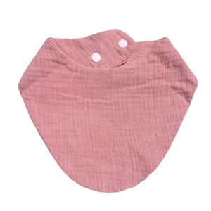 Detailed view of pink cotton gauze baby bib with adjustable double white snap fasteners