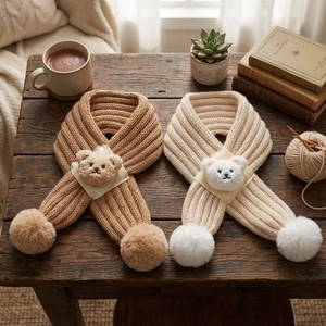 Chunky knit baby bear scarf in caramel and cream white with soft decorative pom-poms