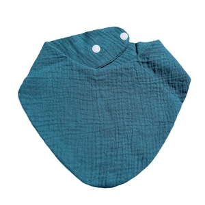 Close-up of muslin cotton baby bandana bib in dark teal with double snap fasteners