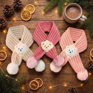 Three-piece knitted baby scarves with teddy bear motif and pom-poms for winter warmth