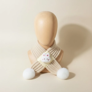 Close-up of soft knit baby scarf with plush rabbit head detail and white pom-poms
