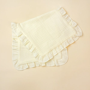 Detail view of double-layered cotton muslin baby burp cloths with elegant ruffled edges