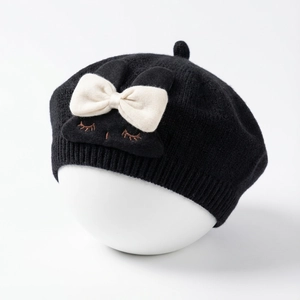 Detail of baby bunny beret featuring soft knit texture with cute ears and bow accent