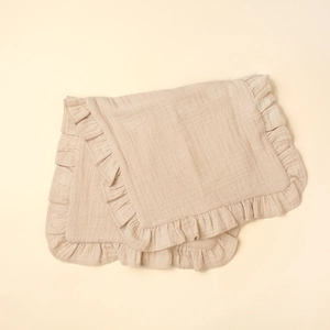 Detailed close-up of muslin cotton burp cloth with ruffle edges and soft texture
