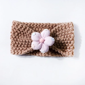 Knitted baby headband in khaki with a 3D pink fabric flower and soft crochet texture