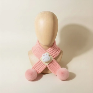 Detailed knit of pink baby scarf with plush bunny and decorative pom-pom accents