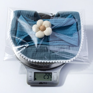 Weight measurement of 29.4g for baby gauze bib and floral headband set in blue